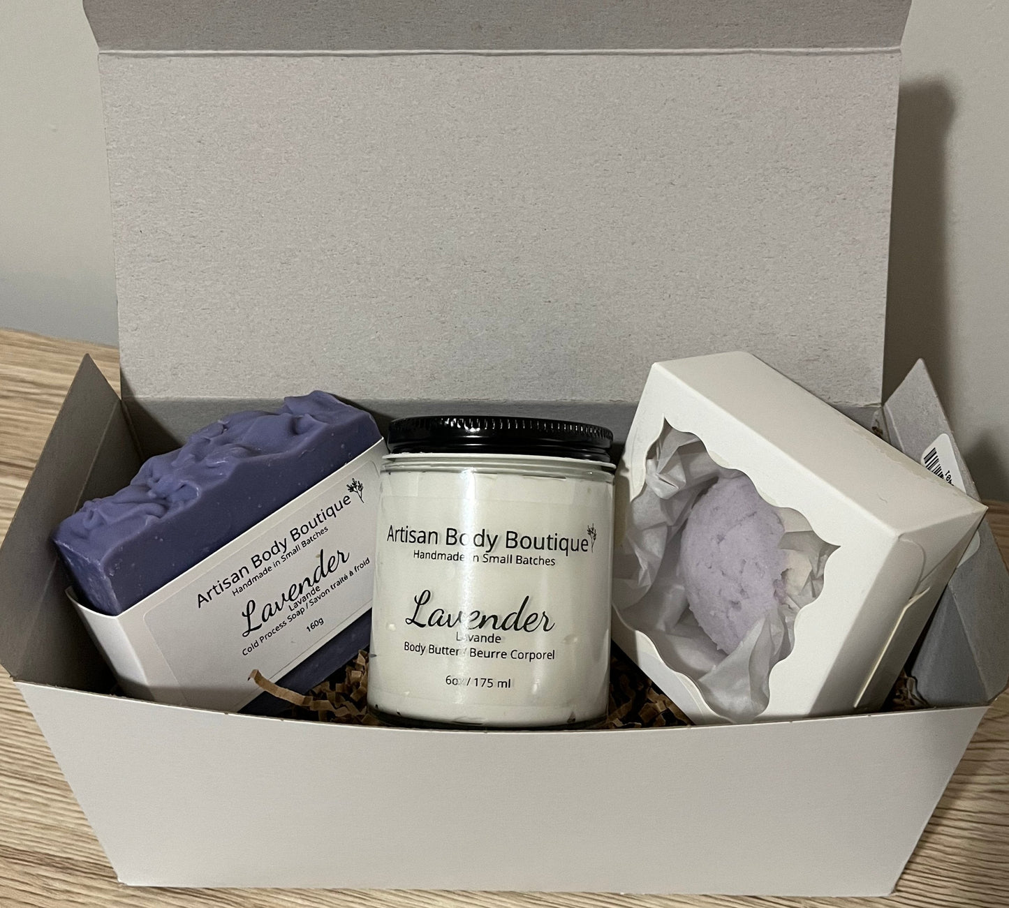 Lavender Bath & Body Gift Set containing a handmade soap and shave bar, lightweight, non-greasy body butter, nourishing Shea butter bath bomb truffle.